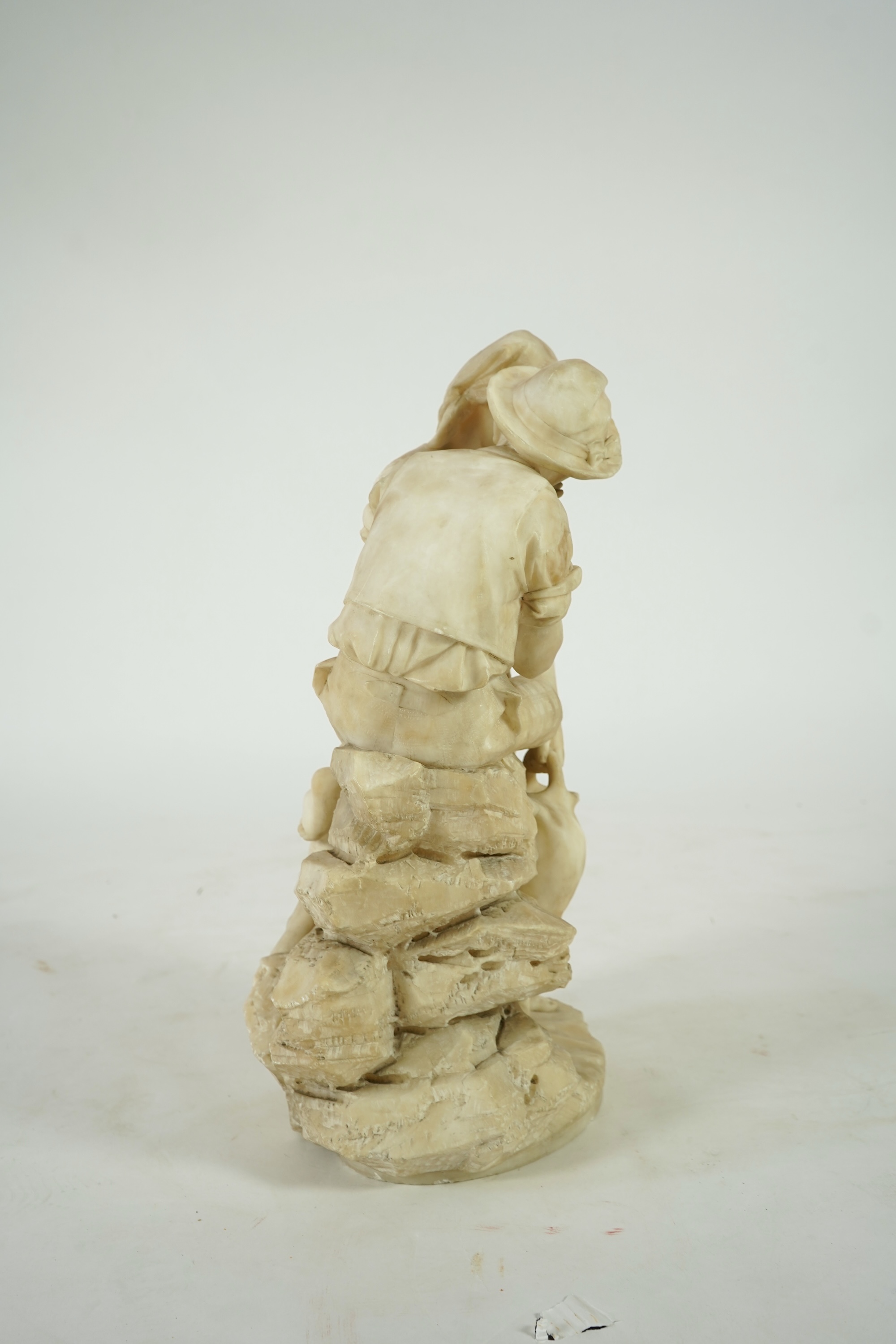 A large Continental alabaster group of a peasant couple, late 19th / early 20th century